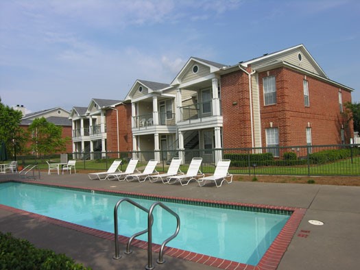 Champion Lake Pool Side View With Pool Lounge Chairs and Balconies